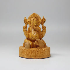 Side view highlighting the 8cm depth and thickness of the 13cm tall hand-carved wooden Ganesha.