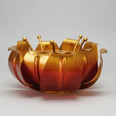 Close-up of the central glass holder inside the metal lotus petal design.