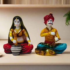 Handcrafted Rajasthani couple statue set in bright ethnic colors, symbolizing Indian tradition and heritage.