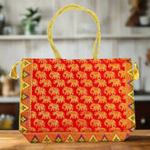 A handmade Banarasi silk tote bag with fine zari work and a sturdy handle.