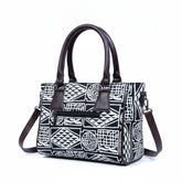 Back view showing the secure exterior zip pocket on the black 10x8 handbag.