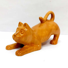 A carved wooden cat figurine, ideal for a tabletop or a shelf.