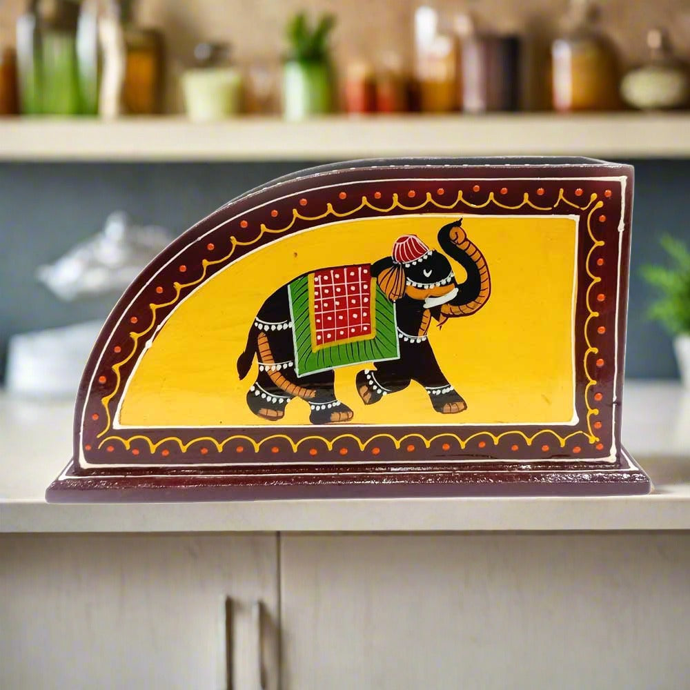 A hand-carved wooden tissue box cover with a detailed elephant design.