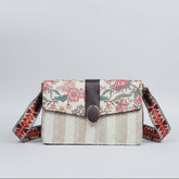 A compact 9x5.5 inch women's handbag featuring a woven floral design and a structured rectangular silhouette.