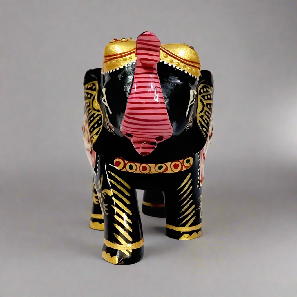 Decorative wooden elephant statue with golden embossed artwork on back and stomach.