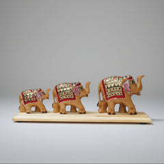 Close-up of the intricate hand-painted floral motifs on a polished wooden elephant bridge, showcasing the artisanal details and vibrant colors.