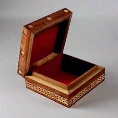 Decorative wooden jewel box with brass border and intricate gemstone painting, perfect for storing small jewelry.