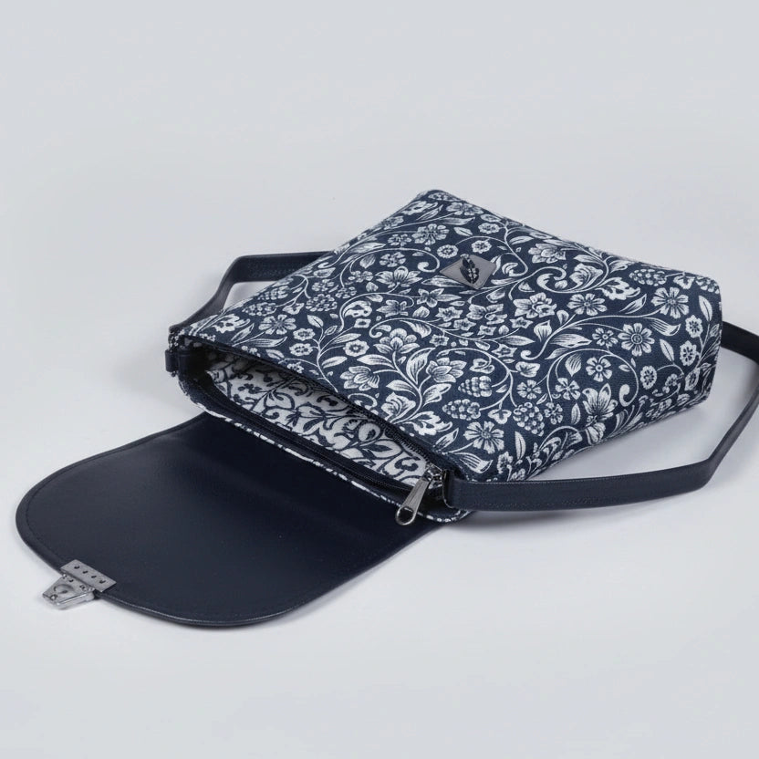 Open view of the handbag showing two separate internal zippered compartments for organized storage