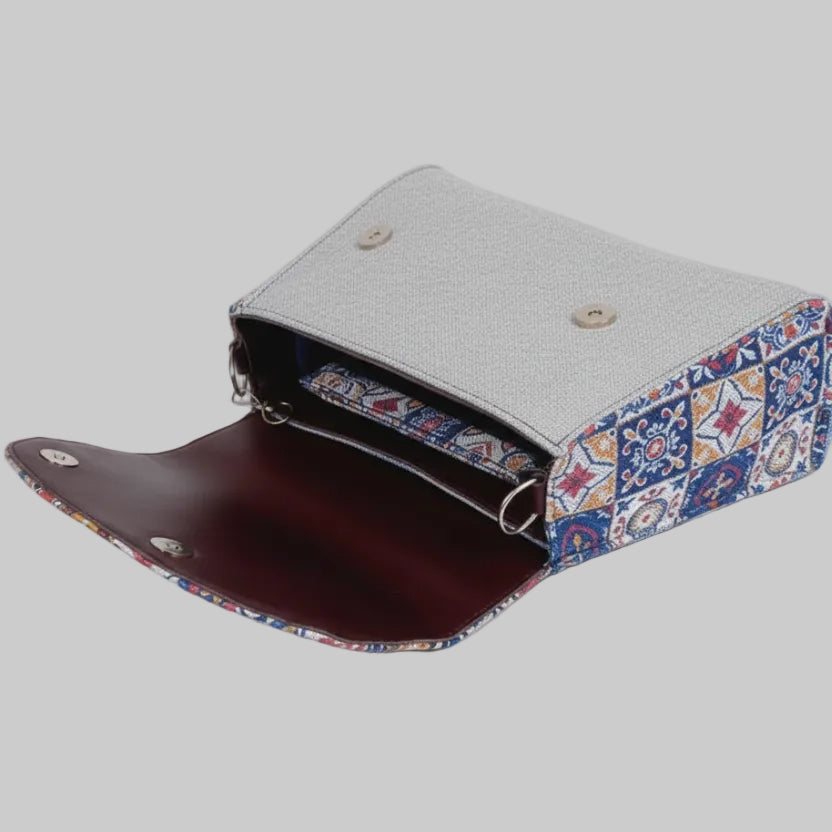 Interior view of two main zip compartments in a floral embellished sling bag