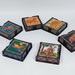 Lifestyle shot of a person placing a tea cup on a vibrant, printed wooden coaster in a cozy kitchen setting.