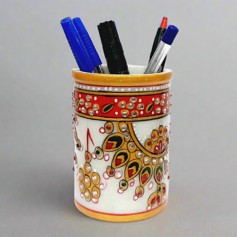 An elegant round marble pen stand, perfect for keeping pens and pencils organized on a study desk.