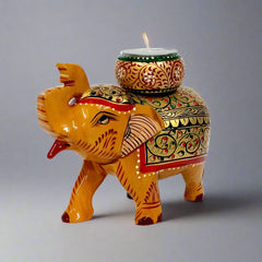 Wooden elephant statue candle holder featuring vibrant multicolor hand-painted details and a round candle space above the trunk.