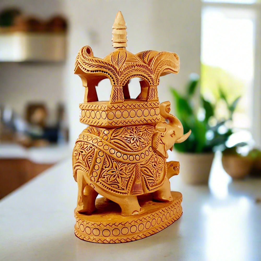 An exquisitely carved wooden elephant showpiece with a detailed pavilion for a king.