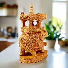 An exquisitely carved wooden elephant showpiece with a detailed pavilion for a king.