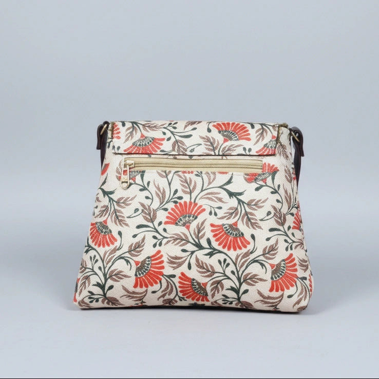 The reverse side of the fabric sling bag highlighting the third zippered pocket for quick-access items.