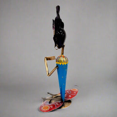 Intricately painted figurine candle stand adding sophistication and charm to living spaces.