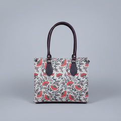 Detailed texture of the premium floral print on the ethnic fabric handbag.
