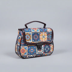 Front view of a small floral ethnic sling bag with button closure and handle