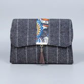 Front view of the floral finesse flap sling bag with textured fabric and leather tassel