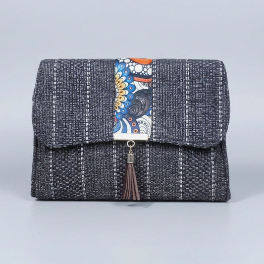 Front view of the floral finesse flap sling bag with textured fabric and leather tassel