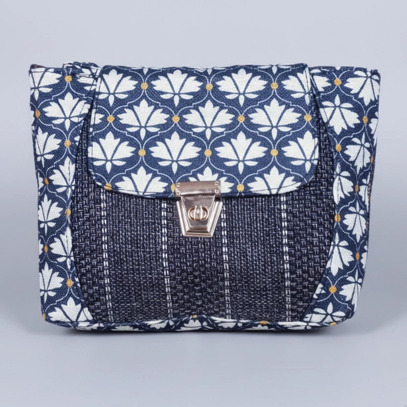 Front view of the 10x8 inch floral Jacquard sling bag with golden button closure