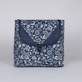 Front view of a 10x10 inch black sling bag with floral motifs and a front flap button closure