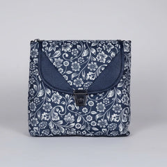 Front view of a 10x10 inch black sling bag with floral motifs and a front flap button closure