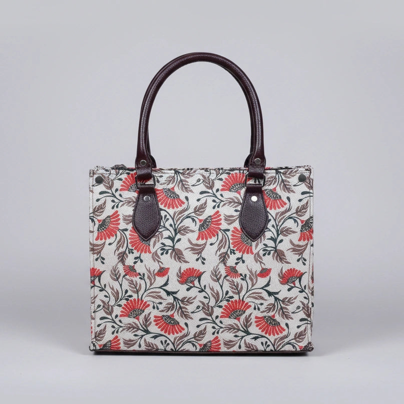 Front view of a premium floral print fabric handbag with PU leather handles.