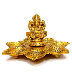 A golden Ganesh sculpture with 7 lamps, symbolizing the strength and stability of Lord Ganesha.