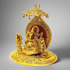 A golden Ganesha statue with his wives Riddhi and Siddhi, bringing prosperity and success.