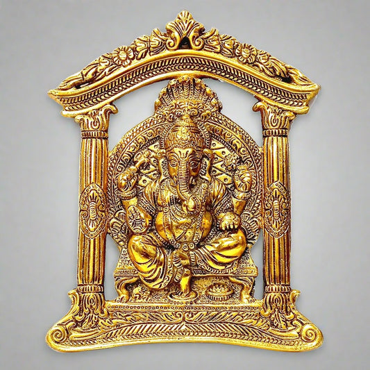 A golden metal Ganesha wall decor piece with a wonderful design.