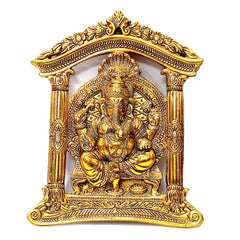 A golden oxidized metal art piece of Lord Ganesha, a spiritual and beautiful wall decoration.