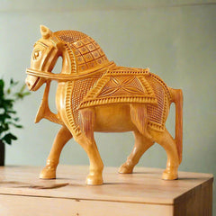 A beautiful hand-carved wooden statue of a walking horse.