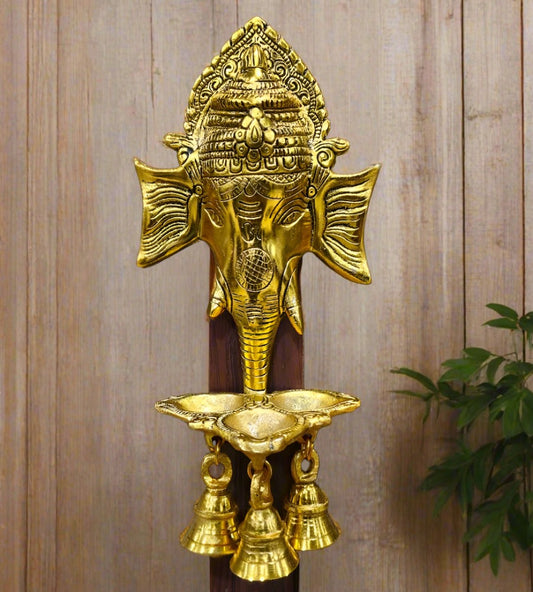 A hand-painted Ganesha wall decor piece featuring a ringing bell and intricate details.