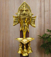 A hand-painted Ganesha wall decor piece featuring a ringing bell and intricate details.