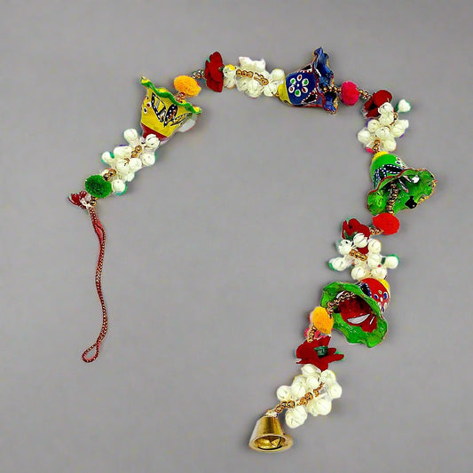 A hand-painted papermache toran, a traditional and vibrant door hanging.