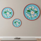 A hand-painted Rajasthani decorative wall plate featuring a delicate lotus bloom motif, symbolizing grace and new beginnings, on a premium seasoned wood base.