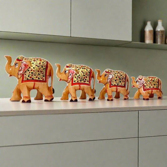 A hand-painted wooden elephant family set of 4 pieces, perfect for home decor.