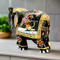 A hand-painted wooden elephant statue, a perfect decoration for a home or office.