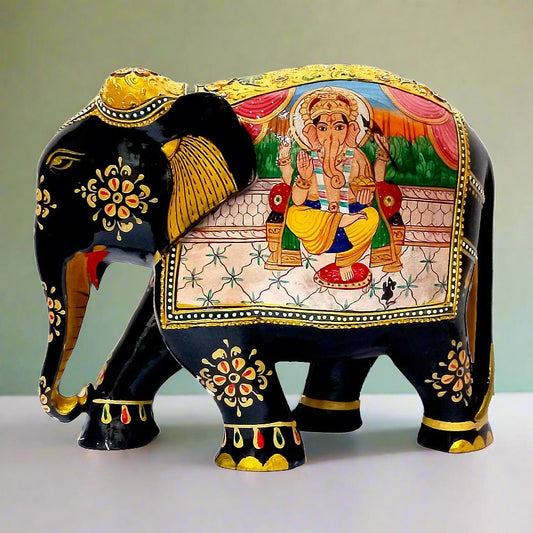 A hand-painted wooden elephant statue featuring a beautiful depiction of Lord Ganesha.