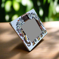 A hand-painted wooden makeup mirror, perfect for travel and keeping in a purse.