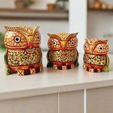 A set of 3 hand-painted wooden owls in big and small sizes, perfect for decoration.