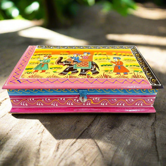 A hand-painted wooden trinket box with a traditional Indian miniature art design.