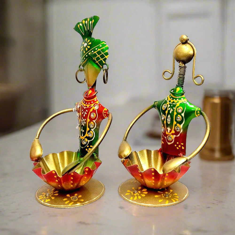 A handcrafted couple showpiece with a tea-light holder, ideal for home decoration.