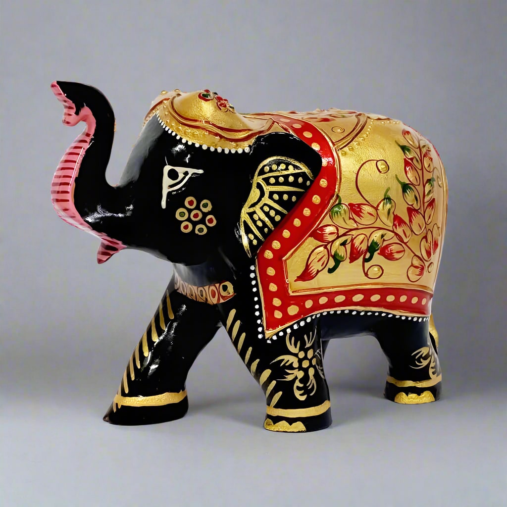 Handcrafted wooden elephant sculpture with fine painted detailing on body and face.