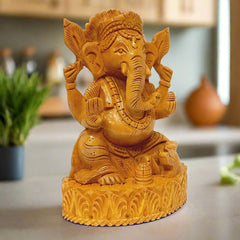 Handcrafted Ganesha statue made from a single piece of wood with fine detailing.