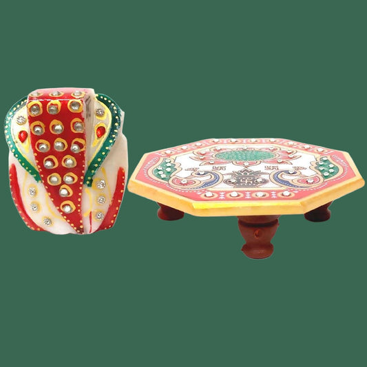 Handcrafted marble Chowki Ganesha idol with intricate artwork.