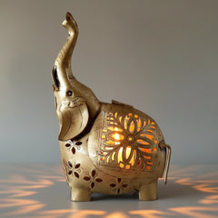 Handcrafted metal elephant figurine with internal candle holder for warm ambient lighting.