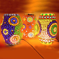 A handcrafted mosaic lantern with assorted, unique designs and patterns.