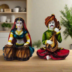Set of two polyresin statues representing a traditional Rajasthani man and woman in vibrant cultural dress.